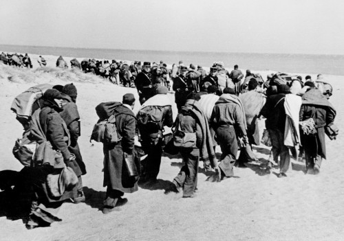 FRANCE. March 1939. Between Argeles-sur-Mer and Le Bercares. Exiled Republican soldiers and civilians, who crossed the border after Franco's victory, being transferred from one refugee camp to another. A French Gendarme heads the column of refugees. France had set up eight camps along the border in the PyrŽnŽes Orientales region.