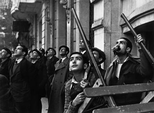 SPAIN. Spanish Civil War (1936-9) ICP 280. Barcelona. January, 1939. Watching an air raid over the city. Barcelona was being heavily bombed by fascist planes, as General Franco's troops rapidly approached. The Spanish Civil War broke out in 1936, when part of the Spanish army rebelled against the Second Republic, a democratic government elected in 1931. It gained international dimensions when Fascist Germany and Italy began supporting the military uprising, led by General Franco, with weapons and soldiers. The USSR helped the Republic, and a significant contingent of volunteers joined the International Brigades and fought for the Republic. The conflict became the symbol of a larger conflict between Fascists and Communists. The war ended in 1939 with Franco's victory over the Republicans.